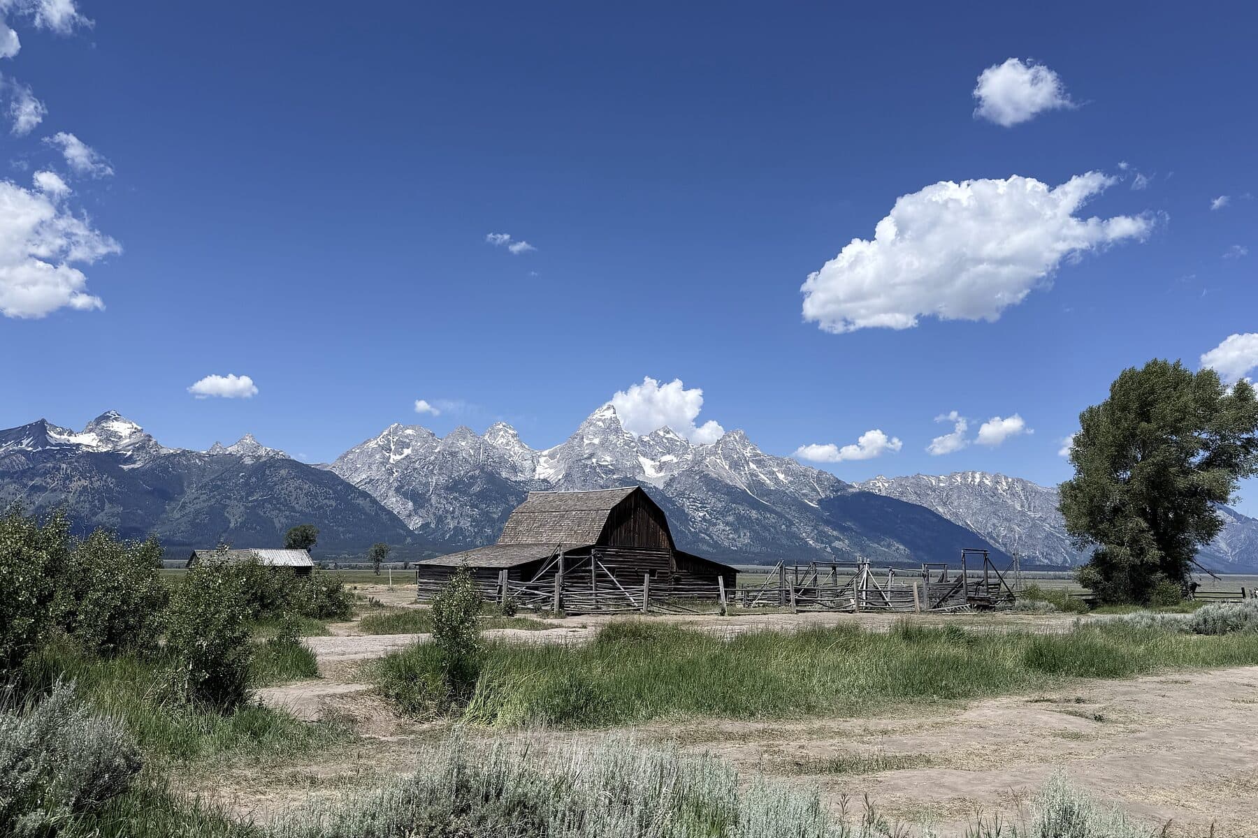 The Moulton barn standing alone on the sage flats below the Teton range under high cloud, Wyoming